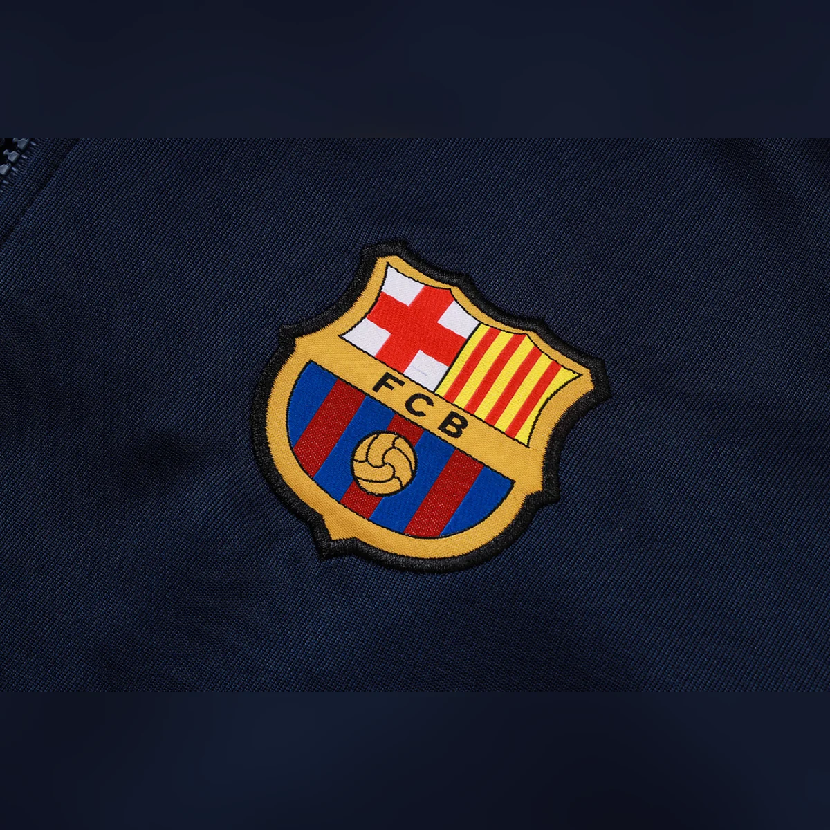 Chándal Barcelona Azul Marino Bandas Rojas 2026/27 – detalle del escudo
